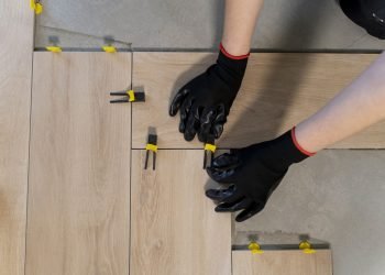 top-view-worker-tiling-floor